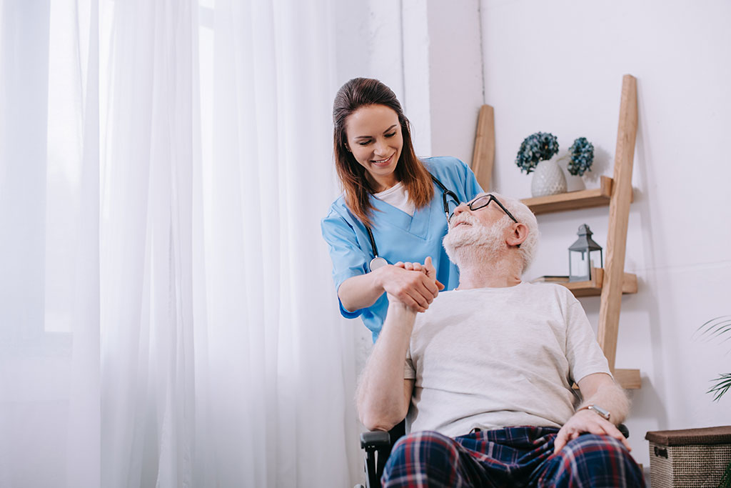 A caregiver sharing a warm moment with an older adult at home